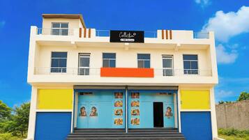 A two-story building with a sign indicating it is 'OOO-Serviced.'
