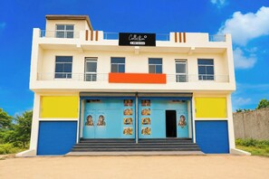 A two-story building with a sign indicating it is 'OOO-Serviced.'