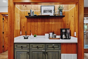 A kitchen with wooden paneling, a white countertop, and built-in cabinets. - 5 Primary En-Suites on First Floor, Hot Tub, Sauna (Wintergreen Resort)