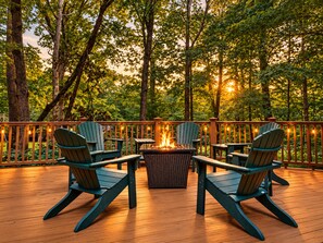 An outdoor deck with Adirondack chairs, a fire pit, and a wooden railing. - 5 Primary En-Suites on First Floor, Hot Tub, Sauna (Wintergreen Resort)
