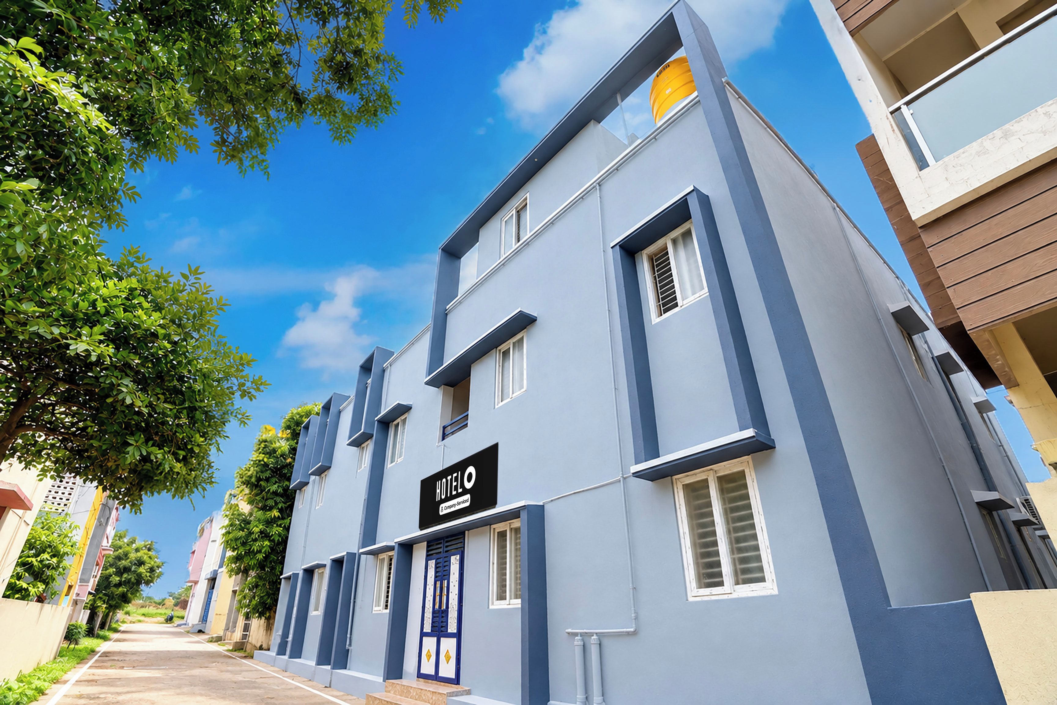 A hotel building with a sign reading 'HOTEL' and a blue facade.