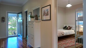 A bedroom with a bed, a bedside table, a lamp, a bunk bed, and a door leading to a balcony. - Gecko at 121 the getaway you have been wanted (Werri Beach)
