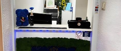 A reception desk with a sign for 'Baroko Rooms & Apartments Reception.'