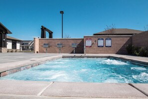 A swimming pool with a lifeguard tower, spa rules, and pool rules signs. - Bright 2-Bedroom Home with Mountain Views (Hyrum)
