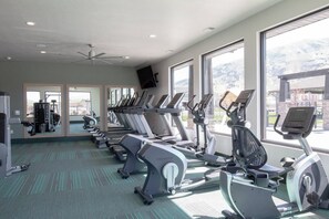 A gym with multiple treadmills, exercise bikes, and free weights. - Bright 2-Bedroom Home with Mountain Views (Hyrum)