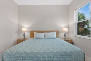 A bedroom with a bed, two bedside tables, and a window. - 🌴Sandpiper Shores | Heated Pool + Steps to Beach 🌴 (Fort Myers Beach)