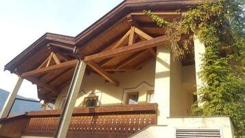 A building with a wooden balcony and a window.