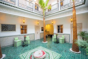 A spacious indoor area with a high ceiling, decorative iron railings, and a patterned floor. - Riad Nah Nah & SPA (Marrakech)
