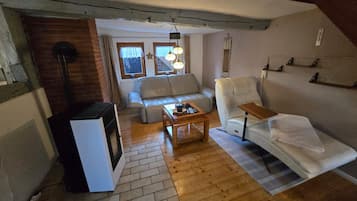 A cozy living room with a sofa, armchair, and a coffee table.