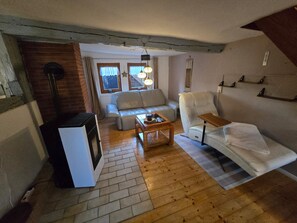 A cozy living room with a sofa, armchair, and a coffee table.