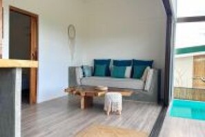 A modern interior with a sofa, a small table, and a child’s chair.