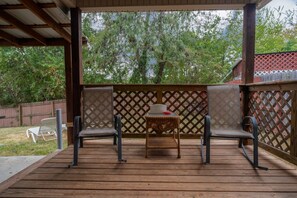 A covered outdoor patio with two chairs and a small table. - Quiet neighborhood home with private patio, free parking & easy airport access (Nashville)