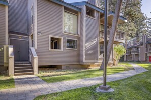 A multi-story residential building with a visible entrance, a small porch, and a paved walkway. - Lake days, mountain adventures & resort amenities right outside your door (South Lake Tahoe)