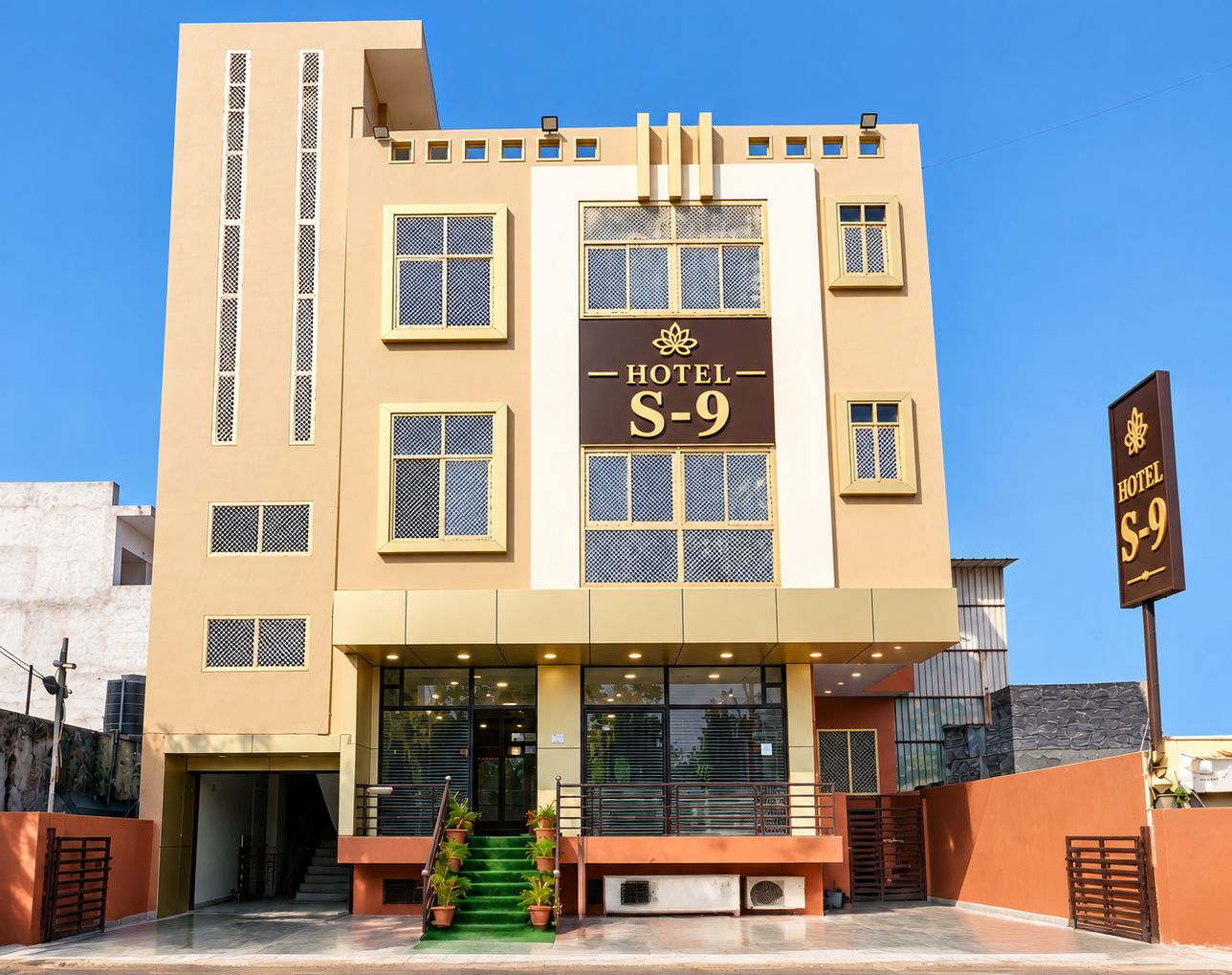 A hotel with a sign reading 'HOTEL S-9' and a staircase leading to the entrance.