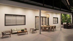 A modern interior with a sofa, dining table, chairs, and a large window. - 15BR house with private pool in Sonoma Resort (Kissimmee)