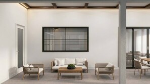 A modern living room with a sofa, two armchairs, a coffee table, and a large framed artwork on the wall. - 15BR house with private pool in Sonoma Resort (Kissimmee)
