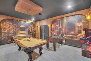 A pool table with a foosball table and a billiards table in a room with arched walls and a mural. - 9BR house sleeps 24 with hot tub and pool (Kissimmee)
