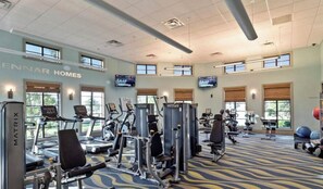 A gym with various exercise equipment, large windows, and a ceiling with recessed lighting. - Stunning 9BR Themed Villa | Immersive Experience (Davenport)
