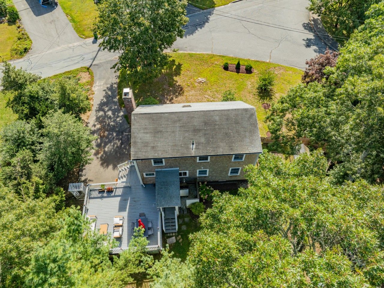 A two-story building with a deck and outdoor seating area.