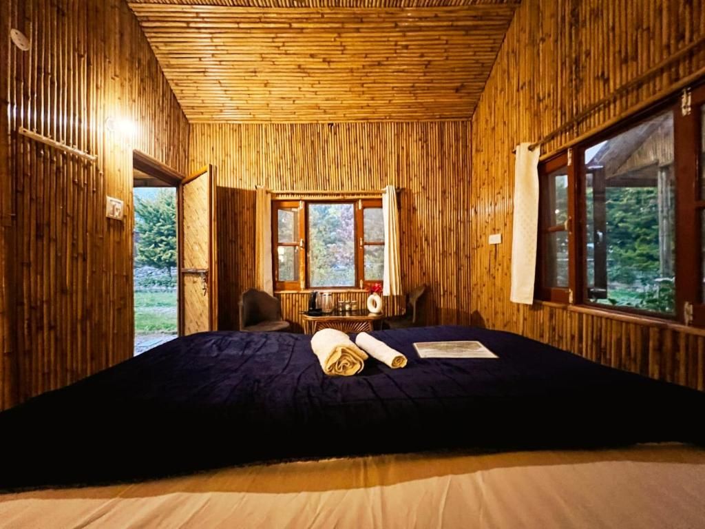 Una habitación con cama, ventana y puerta que da al exterior.