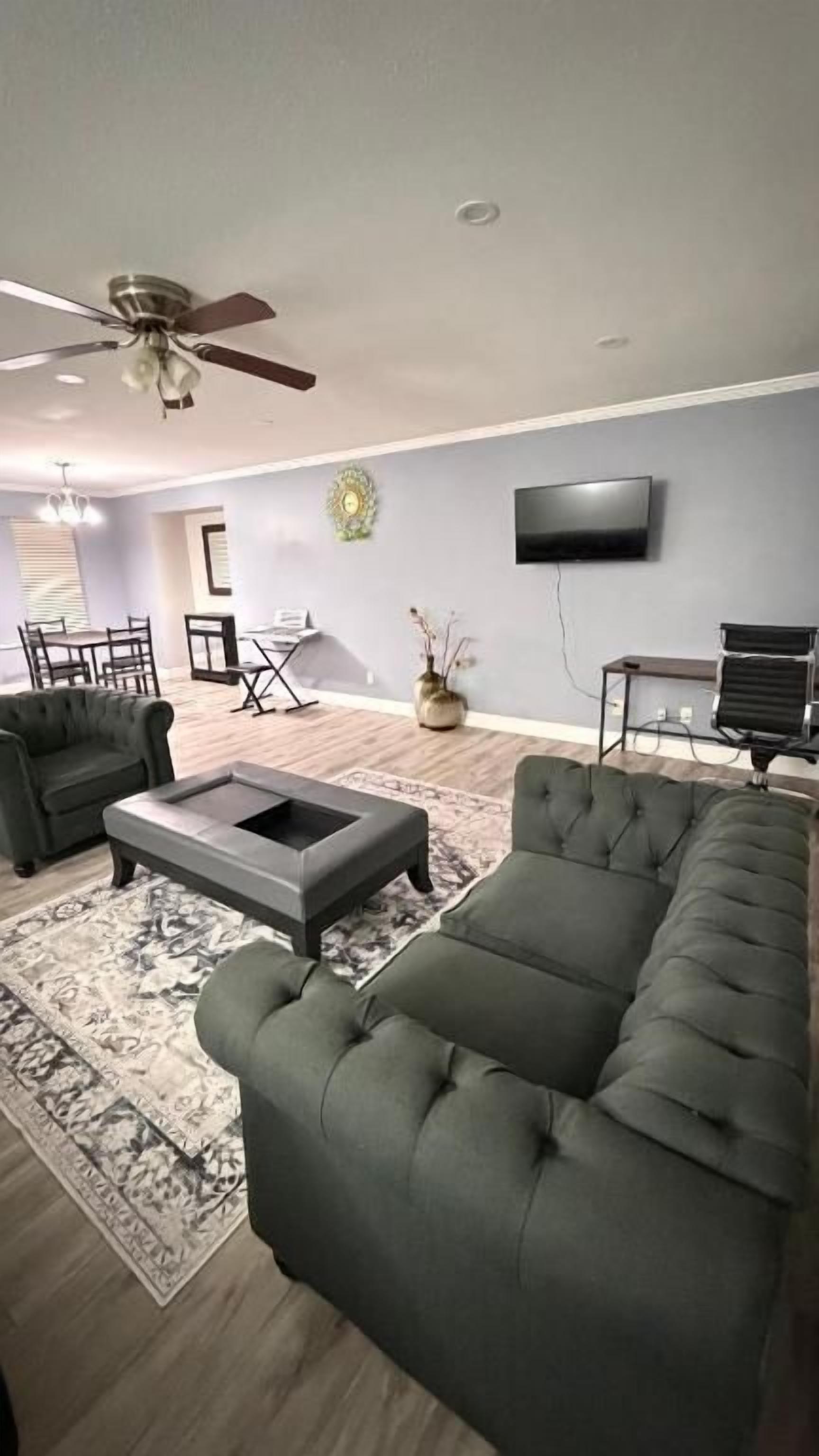 A modern living room with a sofa, armchair, and coffee table.