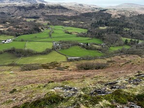 A rural landscape with fields, stone walls, and scattered buildings. - Pandora (Holmrook)