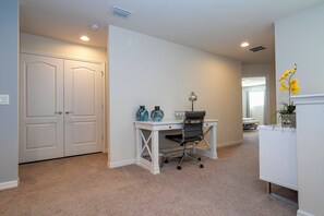 A room with a white desk, two chairs, a white door, and a white wall. - 6BR near Disney | Private pool, spa, movie room (Kissimmee)
