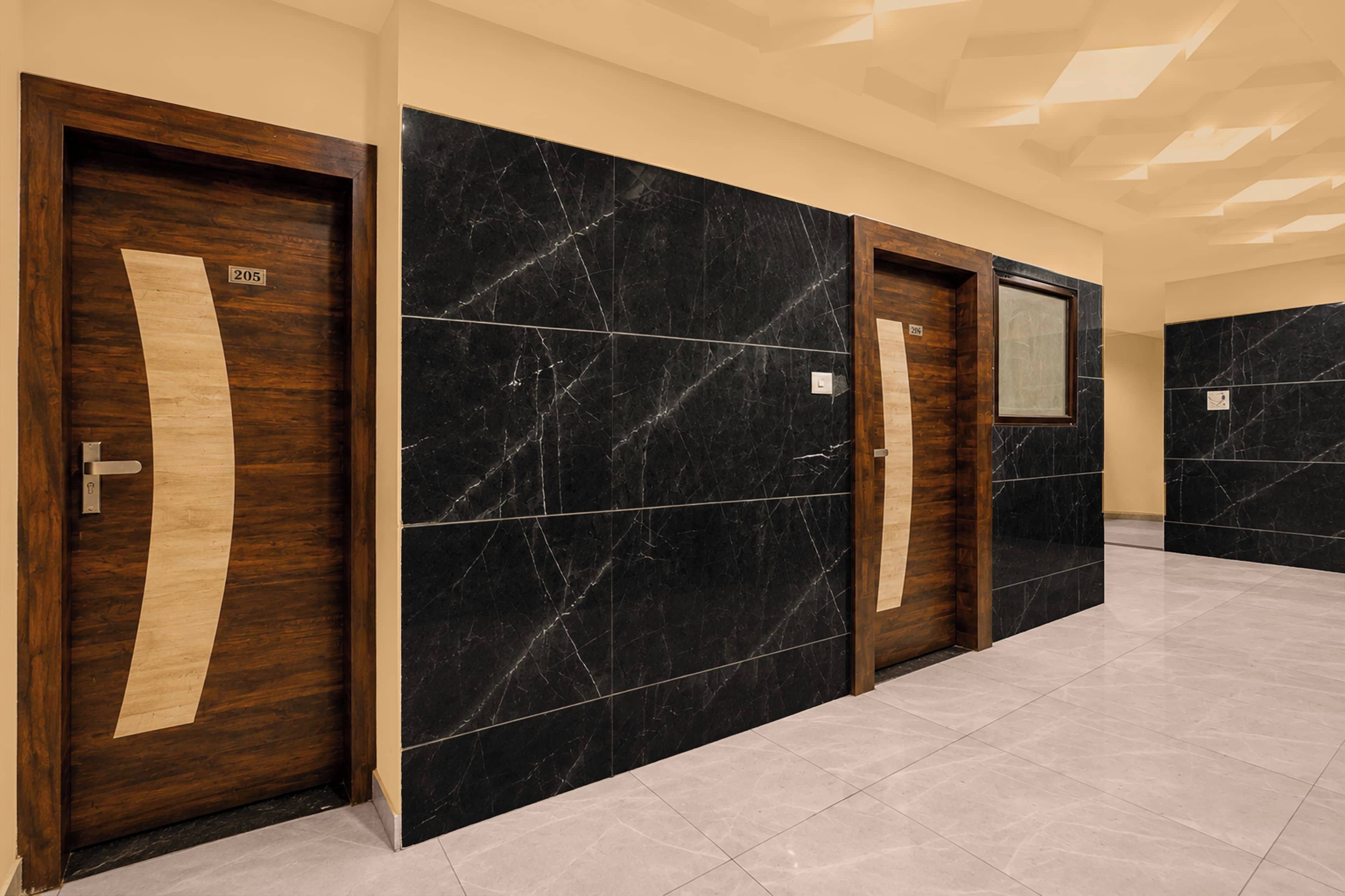 A hallway with three doors, each with a number label.