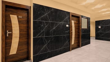 A hallway with three doors, each with a number label.