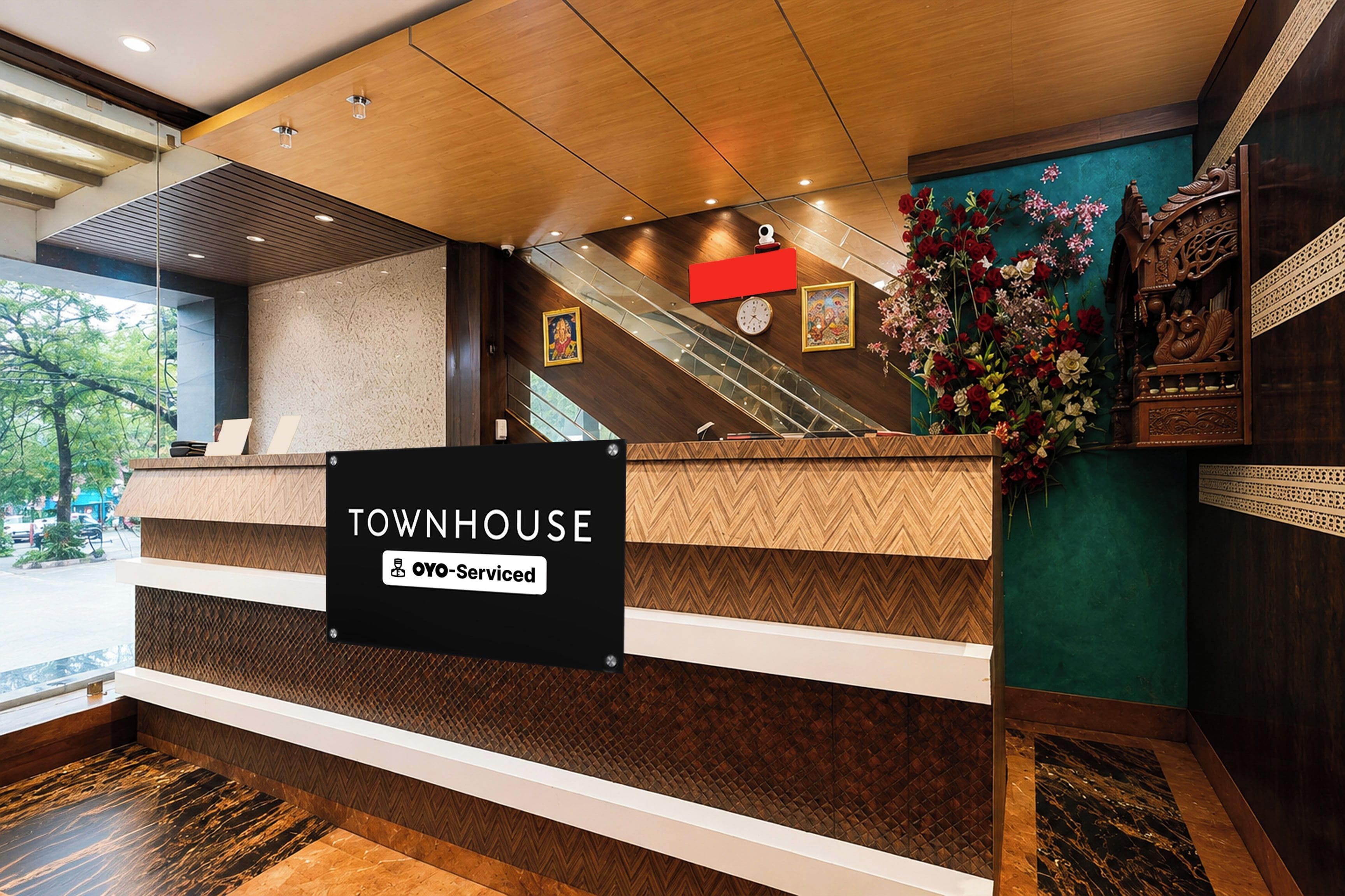 A reception desk with a sign reading 'TOWNHOUSE' and 'YO-Serviced'.