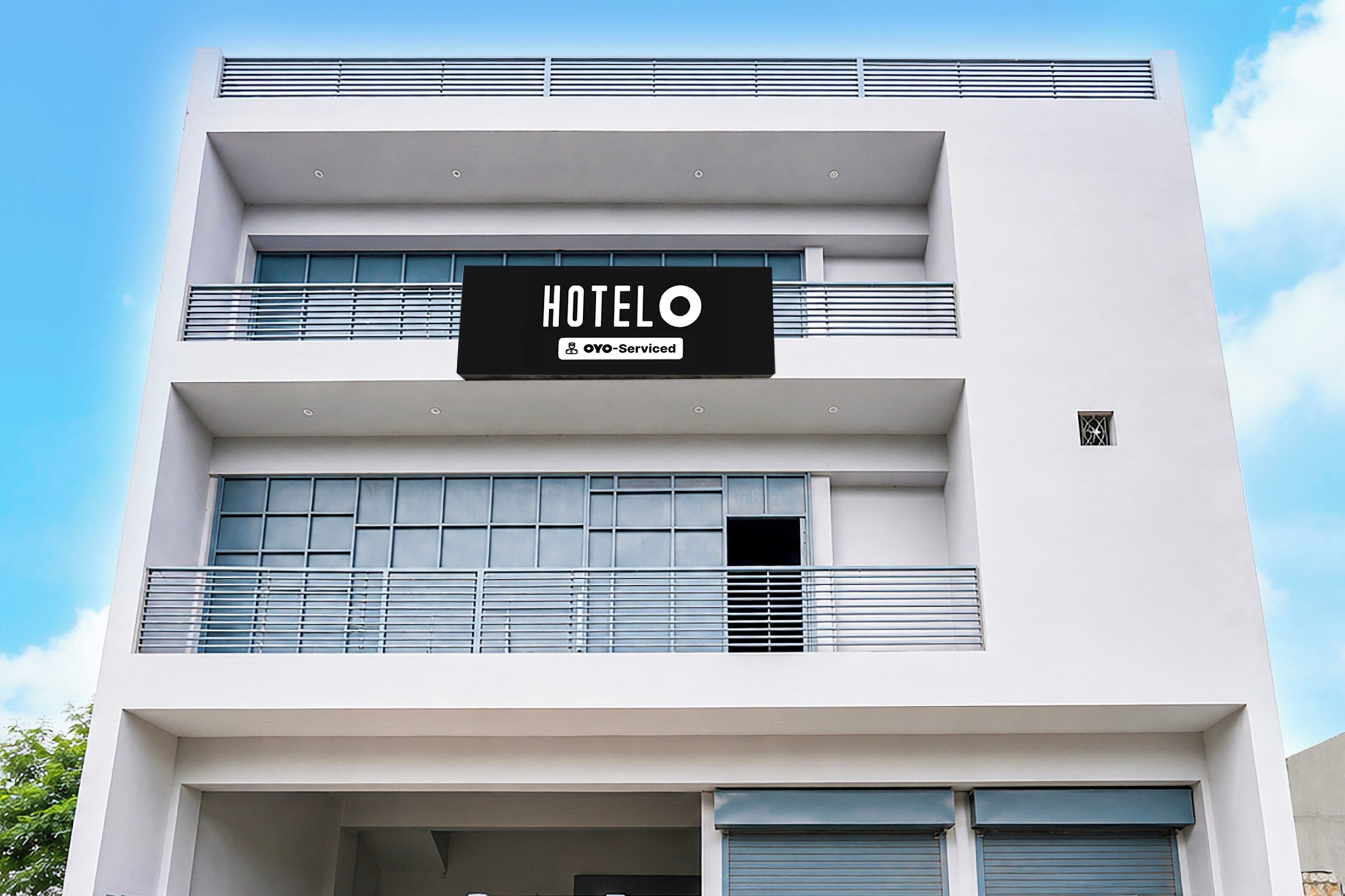 A hotel sign with 'HOTEL' and 'YOY-Serviced' indicating a serviced hotel.