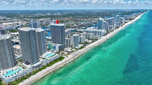 A coastal cityscape with high-rise buildings, a beach, and a clear blue ocean. - Panoramic Ocean View Entire Rental Unit - 2bed/2bath Hotel Suite, Hollywood, FL (Hollywood)