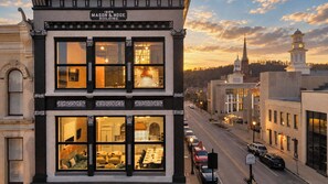 A historic building with a sign indicating it was built in 1888, featuring large windows and a two-story structure. - Lofted Luxury | 5 BR • Sleeps 10 • Downtown! (Frankfort)