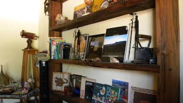 A wooden shelf with various items including books, a globe, and decorative objects.