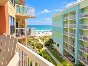 A hotel with multiple balconies overlooking a beach, a pool area, and a clear view of the ocean. - Cute 2 Bed 2 Bath at Harbor Place - Fall Specials! (Orange Beach)