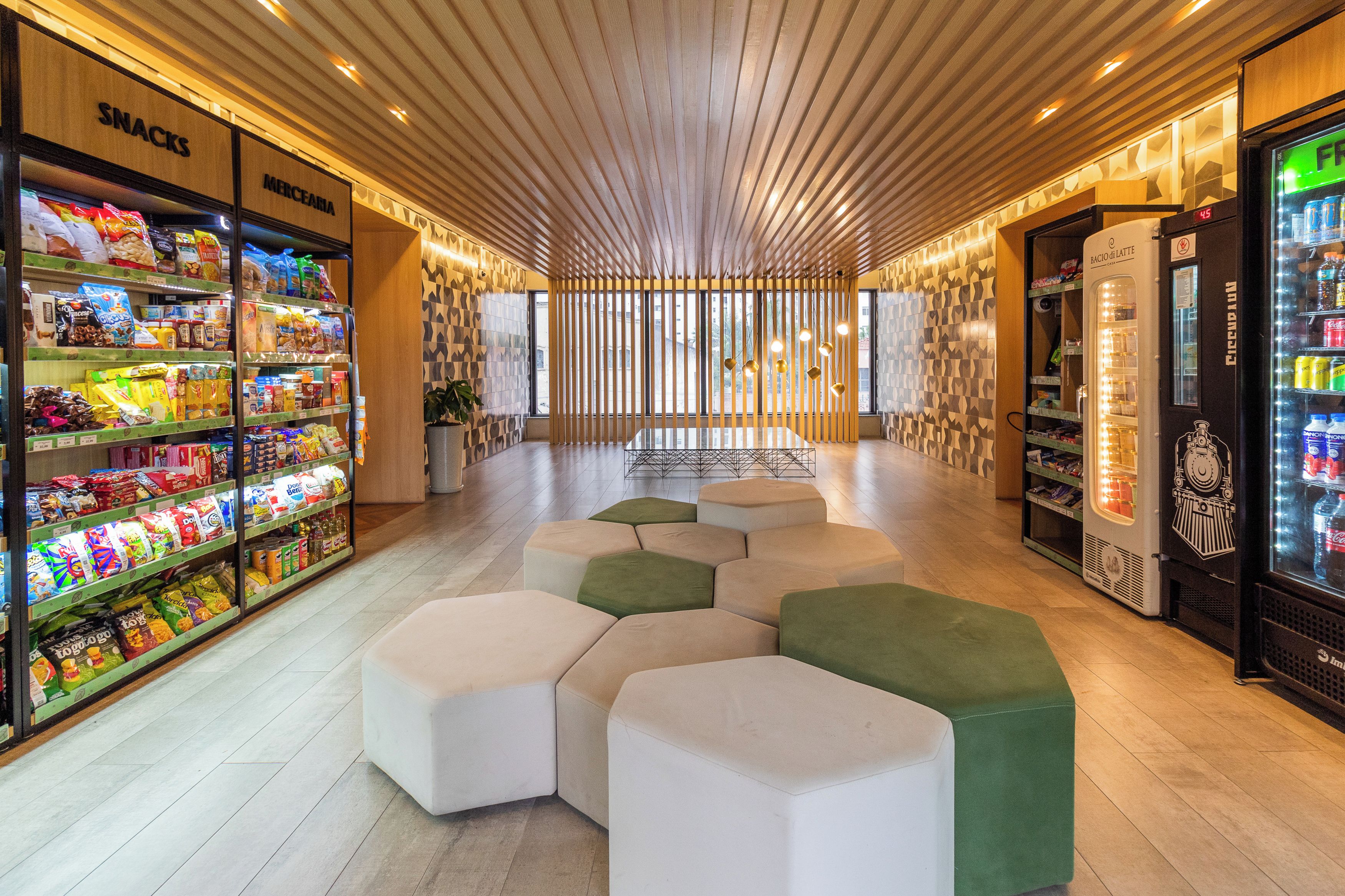 Un interno moderno con ripiani per snack, zone relax e una macchina per bevande.
