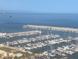 A marina with numerous boats docked, a waterfront promenade, and a clear view of the sea. - Beautiful Beach Front Line Apartment, perfect central location. (Fuengirola)