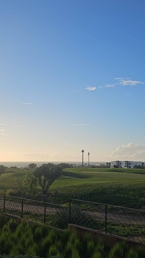A clear sky with a distant view of a residential area, including houses and a tall structure. - Sea View Apt in Taghazout - Pool - Surf & Golf (Agadir)