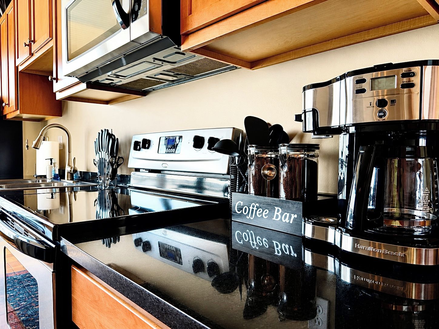 A kitchen with a coffee bar sign, stainless steel appliances, and wooden cabinets.