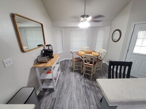 A compact kitchen with a dining area, a ceiling fan, and a mirror on the wall. - Spacious 3 bedroom 2 bath house near Military Bases (Converse)
