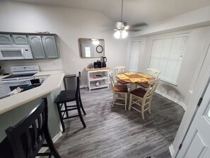 A compact kitchen with a microwave, oven, and a coffee maker on the counter. - Spacious 3 bedroom 2 bath house near Military Bases (Converse)