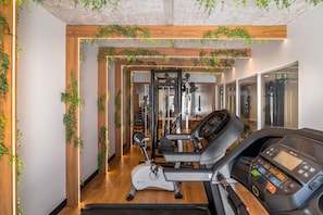 A gym with exercise equipment, a treadmill, and a mirrored wall. - Way Bossa #G2 - Flat in Bessa by Carpediem (João Pessoa)