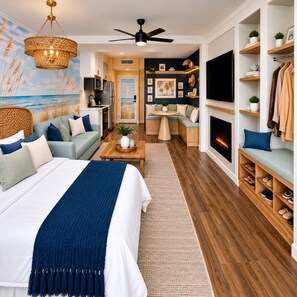 Un dormitorio con una cama grande, ventilador de techo, chimenea y televisor montado en la pared.