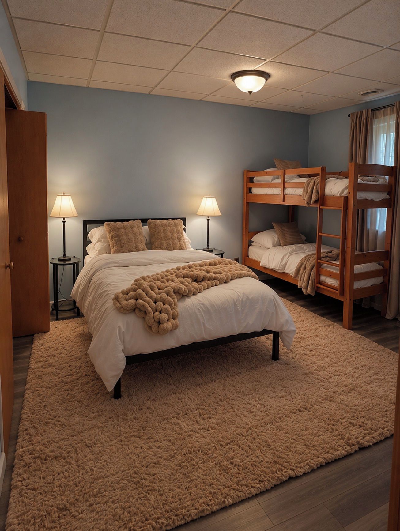 A bedroom with a large bed, two bedside lamps, a bunk bed, and a fluffy rug.