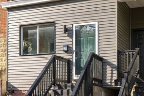 A residential building with a front door, a mailbox, and a window. - 3 Queen BR Home Near Grandview Ave & Inclines (Pittsburgh)