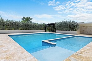 A rectangular swimming pool with a clear blue water surface, surrounded by a tiled deck. - 2BR Townhome w/Fast Wi-Fi, Backyard, Gazebo & Pool (Punta Cana)
