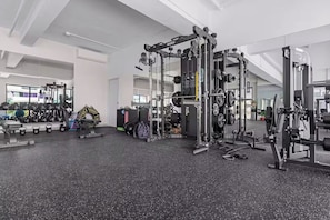 A gym with various exercise equipment, including weight machines and free weights. - High-end 2BR w/Private Pool + BBQ + Steps to Beach (Punta Cana)