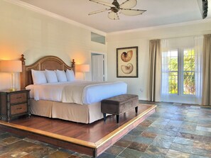 A bedroom with a large bed, bedside tables, a ceiling fan, and a window with curtains. - Take in sweeping panoramic views from this 3-bed, 3-bath penthouse in the heart of Sebastian. (Sebastian)