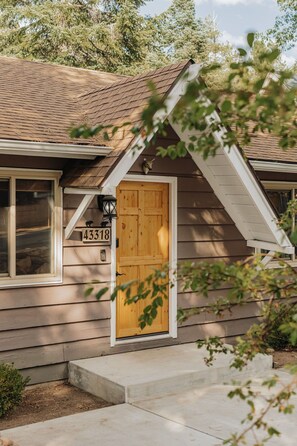 A wooden house with a number '43318' on the door, a window, and a small porch. - Deer & Pine - Hot tub, Dogs ok, Large Patio (Big Bear Lake)