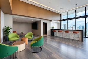 A modern interior with a bar area, seating, and a large window offering a city view.